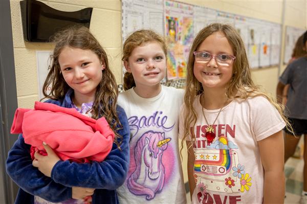 Three girls in the hallway after recess